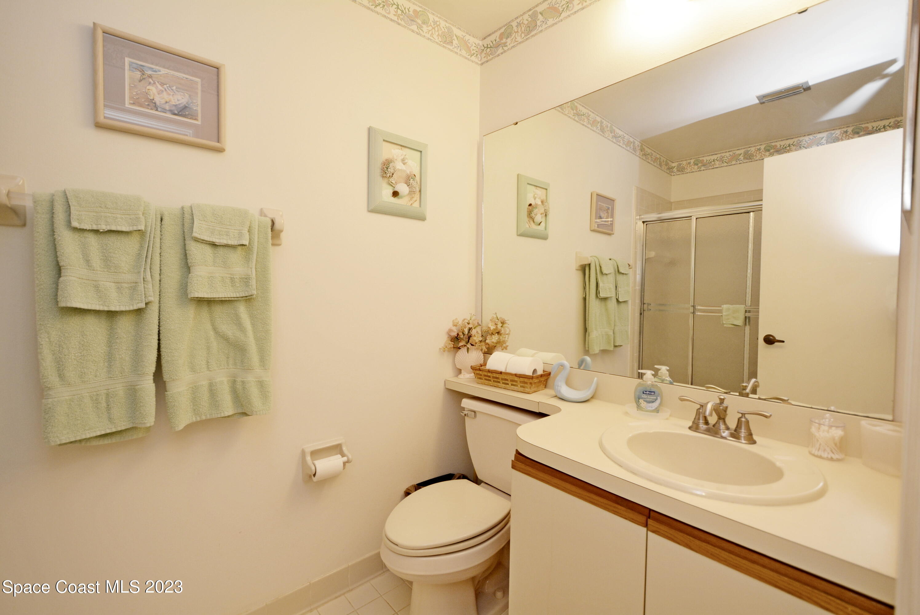 738 Green Valley Lane Melbourne, FL 32940 - Photo 29 of 40 a bathroom with a granite countertop toilet sink and a mirror