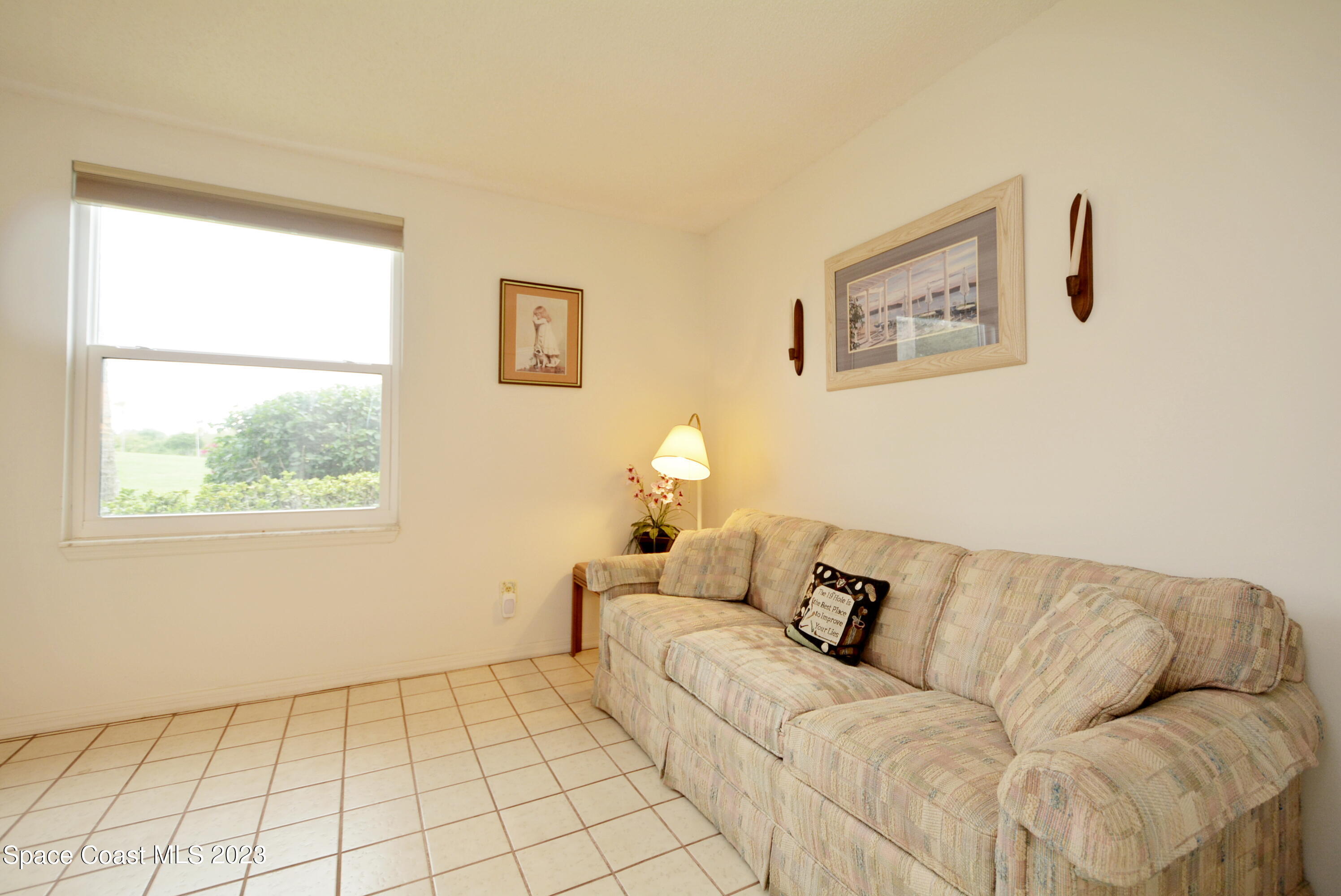 738 Green Valley Lane Melbourne, FL 32940 - Photo 31 of 40 a living room with a couch