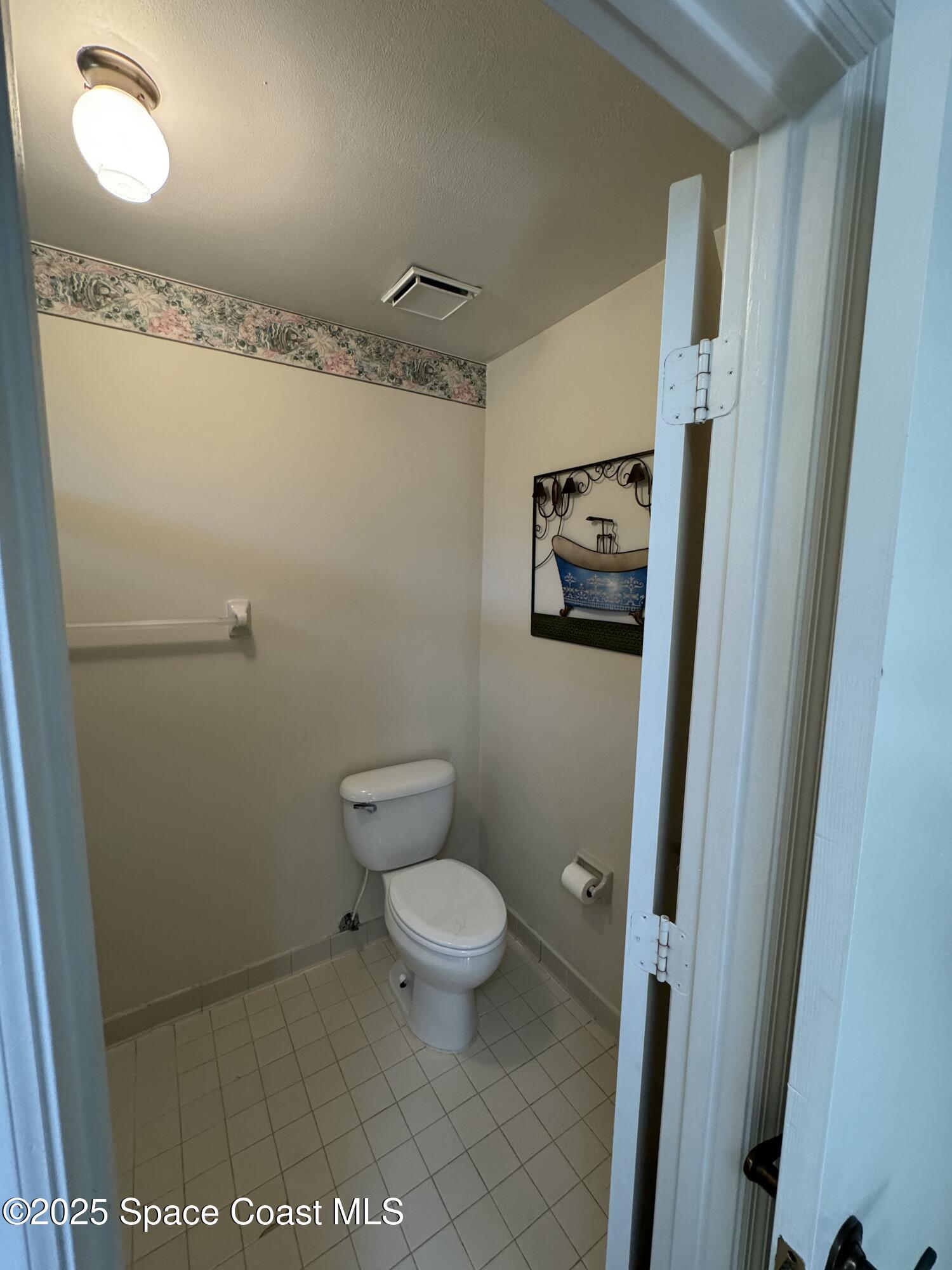 738 Green Valley Lane Melbourne, FL 32940 - Photo 36 of 40 a bathroom with a toilet and a shower