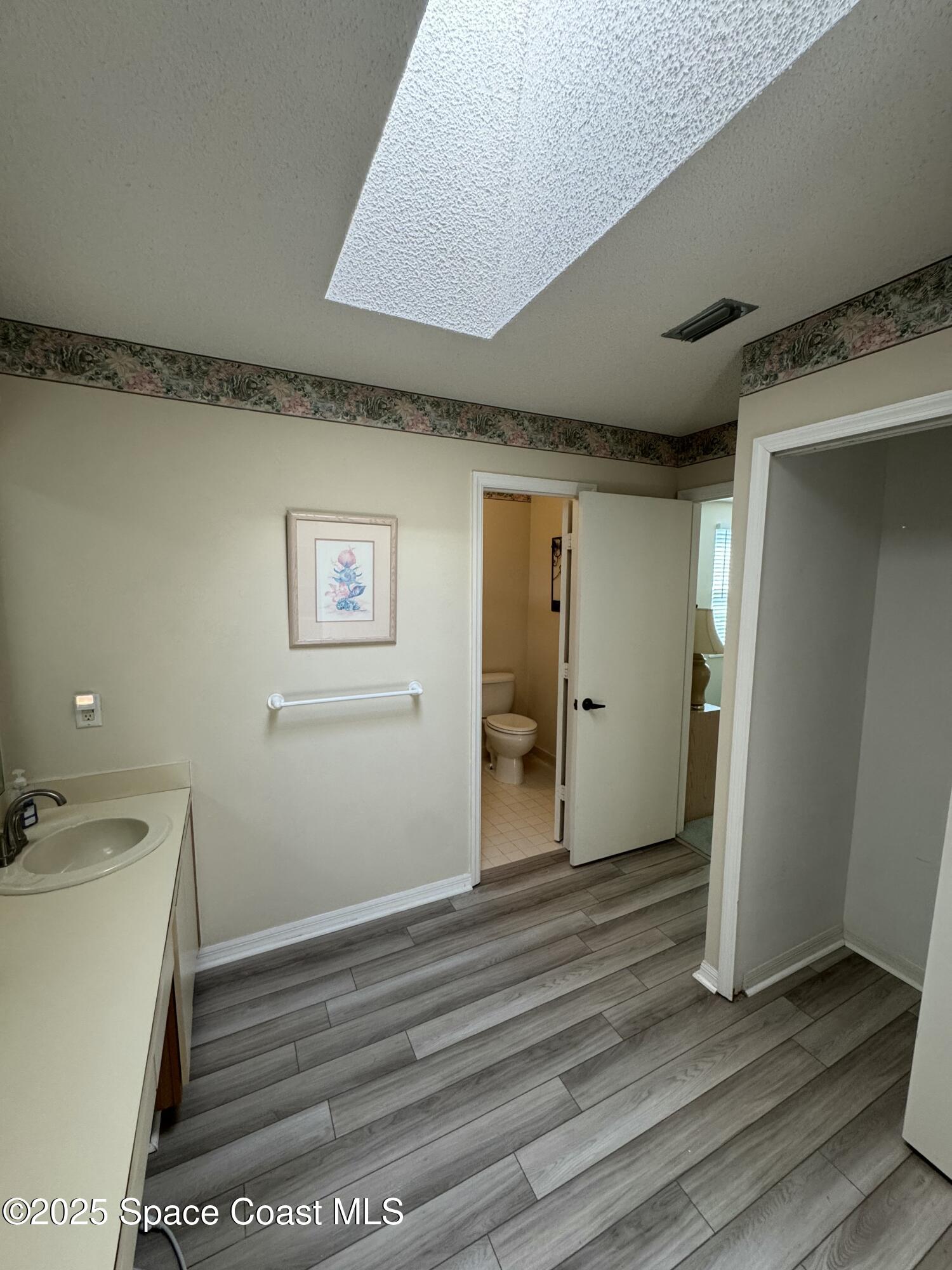738 Green Valley Lane Melbourne, FL 32940 - Photo 38 of 40 a view of a hallway with wooden floor and closet