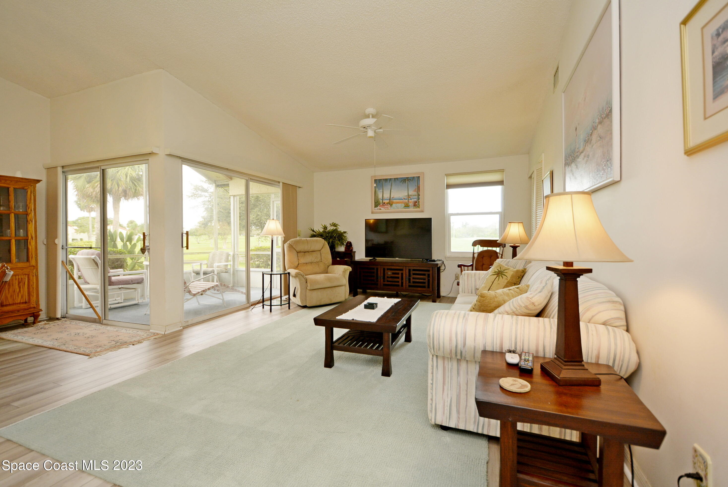 738 Green Valley Lane Melbourne, FL 32940 - Photo 9 of 40 a living room with furniture a flat screen tv and a large window