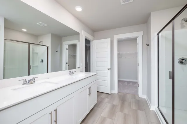 a spacious bathroom with a granite countertop sink mirror and double