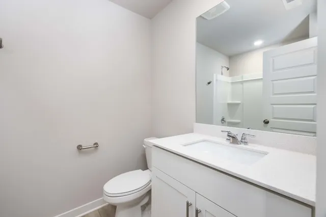 a bathroom with a sink toilet and a mirror