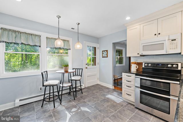 a view of a kitchen with a table and chairs