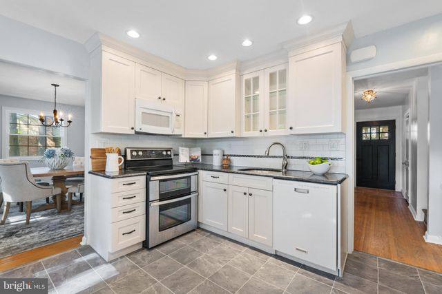 a kitchen with stainless steel appliances granite countertop a stove and a sink