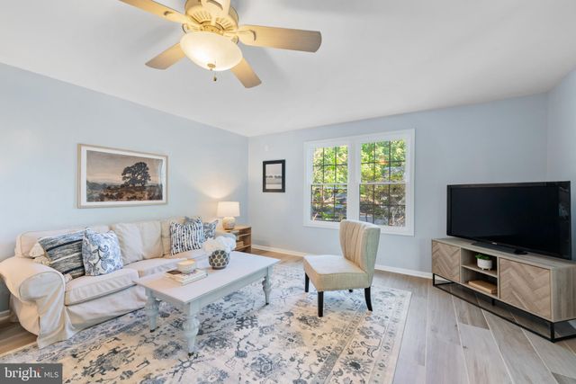 a living room with furniture a window and a flat screen tv