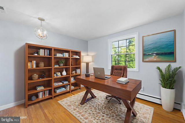 a workspace with furniture window and wooden floor
