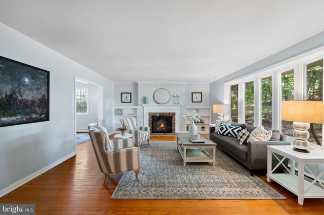 a living room with fireplace furniture and a fireplace