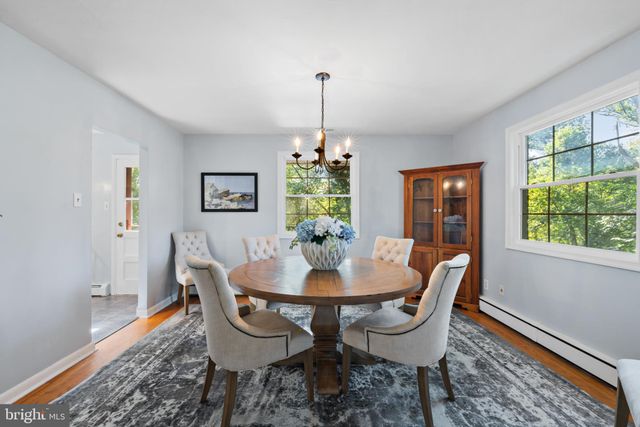 a dining room with furniture a window and a chandelier