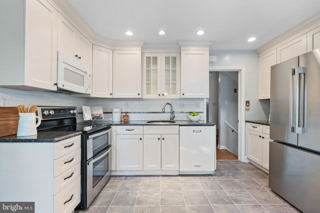 a kitchen with stainless steel appliances granite countertop a refrigerator sink and cabinets