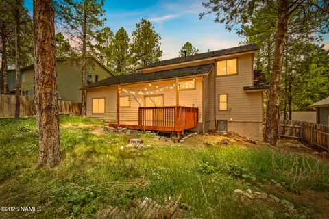 a backyard of a house with a large tree