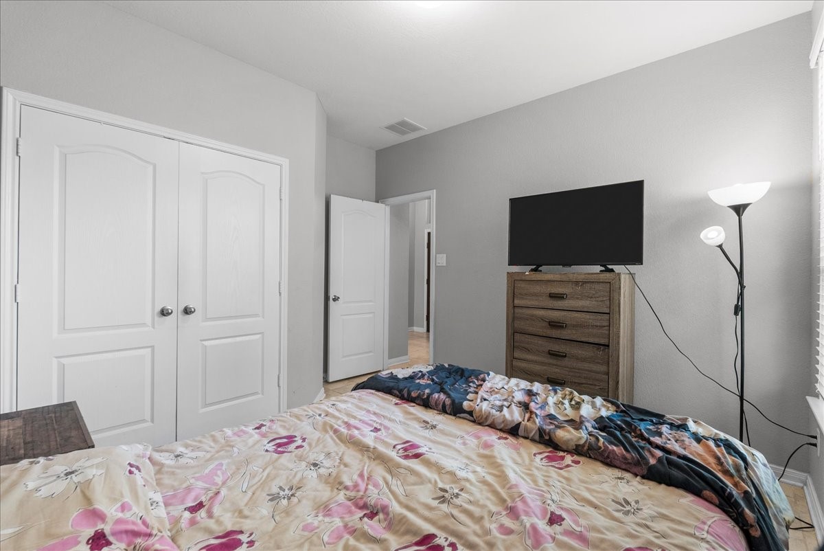 2320 Rosemary Street Rosenberg, TX 77469 - Photo 27 of 40 This bedroom features soft gray walls and a cozy layout. It includes a double-door closet.