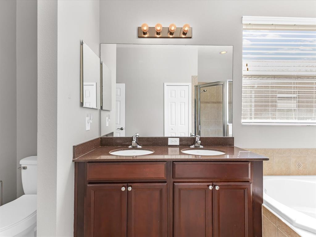 5347 Cappleman Loop Brooksville, FL 34601 - Photo 15 of 28 a bathroom with a sink and a mirror