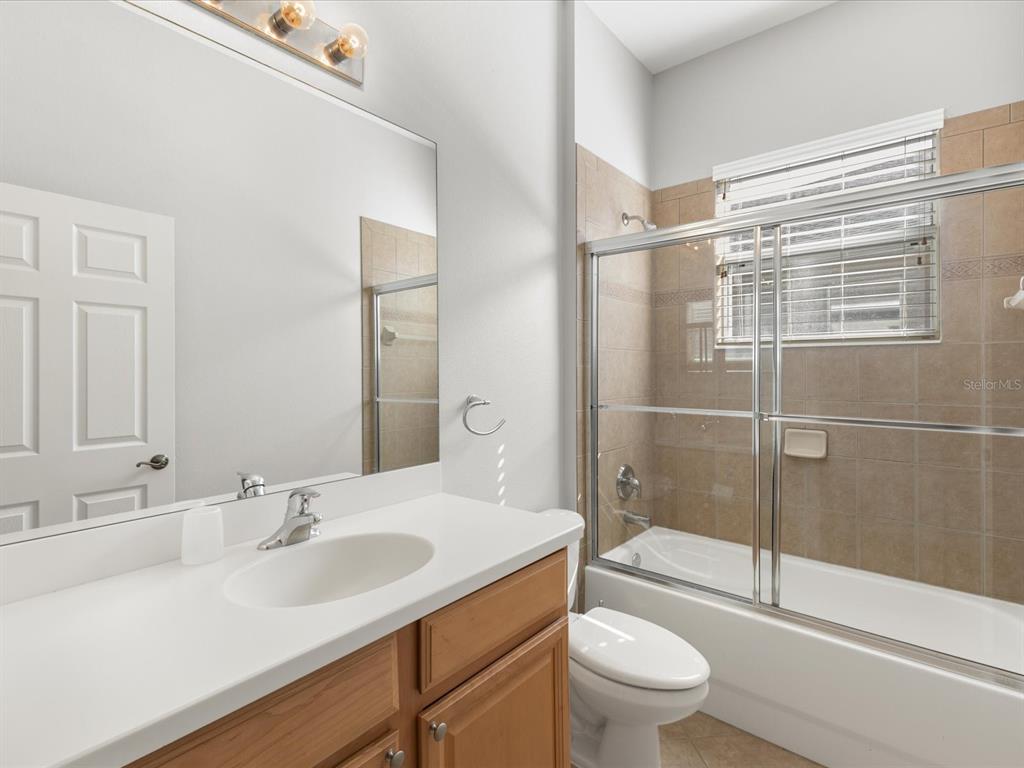 5347 Cappleman Loop Brooksville, FL 34601 - Photo 18 of 28 a bathroom with a sink a toilet and shower