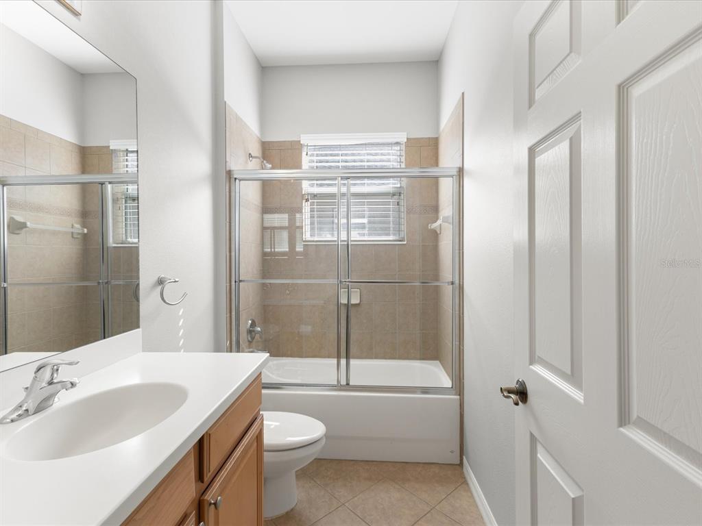 5347 Cappleman Loop Brooksville, FL 34601 - Photo 19 of 28 a bathroom with a granite countertop sink toilet and shower