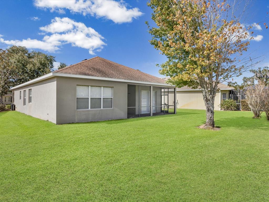 5347 Cappleman Loop Brooksville, FL 34601 - Photo 27 of 28 a view of a house with backyard and garden