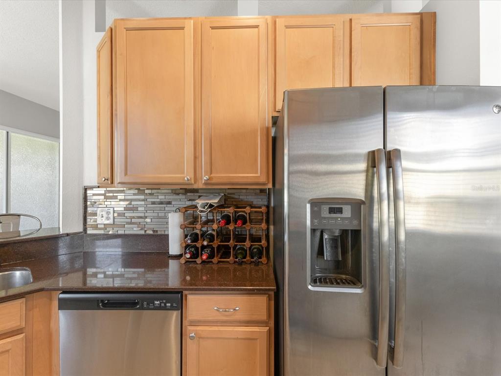 5347 Cappleman Loop Brooksville, FL 34601 - Photo 5 of 28 a kitchen with stainless steel appliances granite countertop a refrigerator and a sink