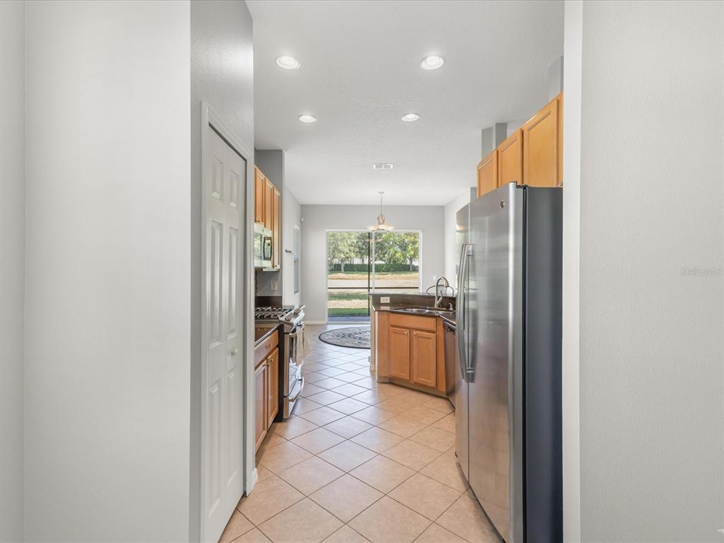 5347 Cappleman Loop Brooksville, FL 34601 - Photo 10 of 28 a kitchen with stainless steel appliances granite countertop a refrigerator and a stove