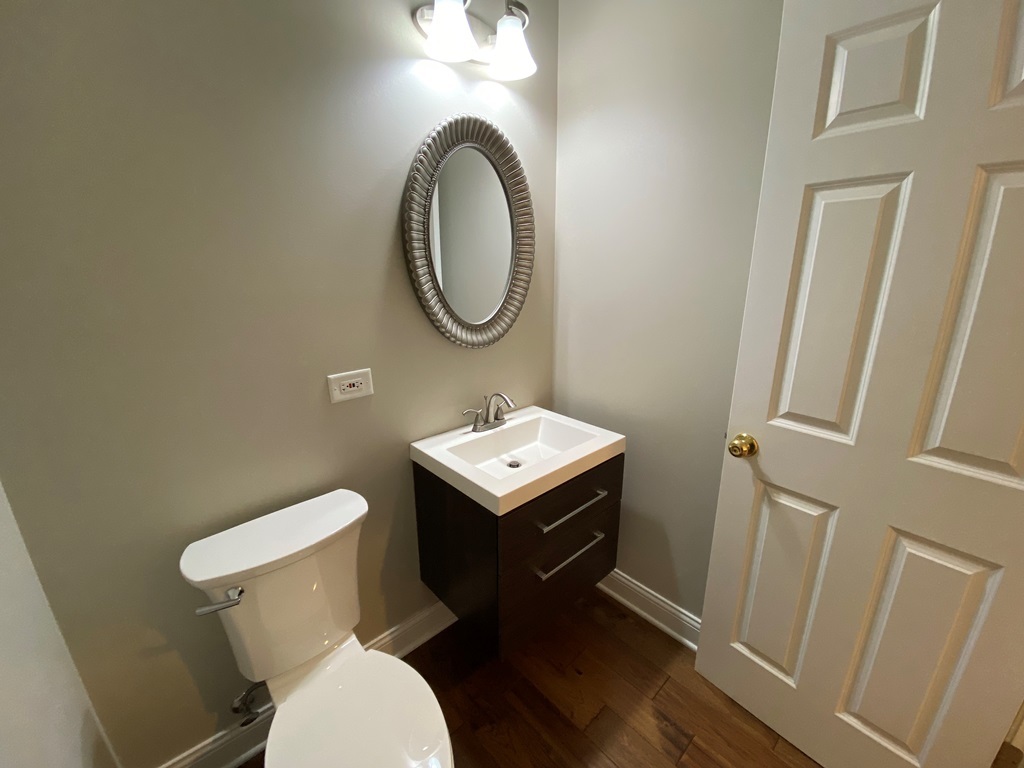 2428 Ridgewood Court Aurora, IL 60502 - Photo 13 of 39 a bathroom with a toilet a sink and a mirror