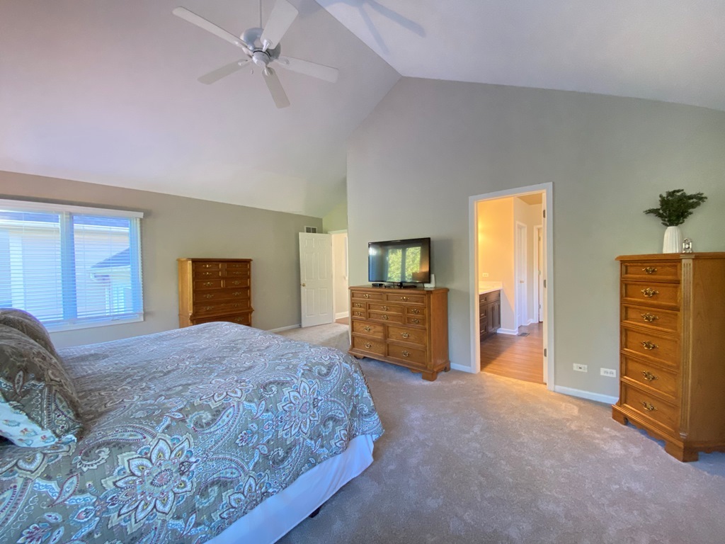 2428 Ridgewood Court Aurora, IL 60502 - Photo 17 of 39 a bedroom with a bed and dresser