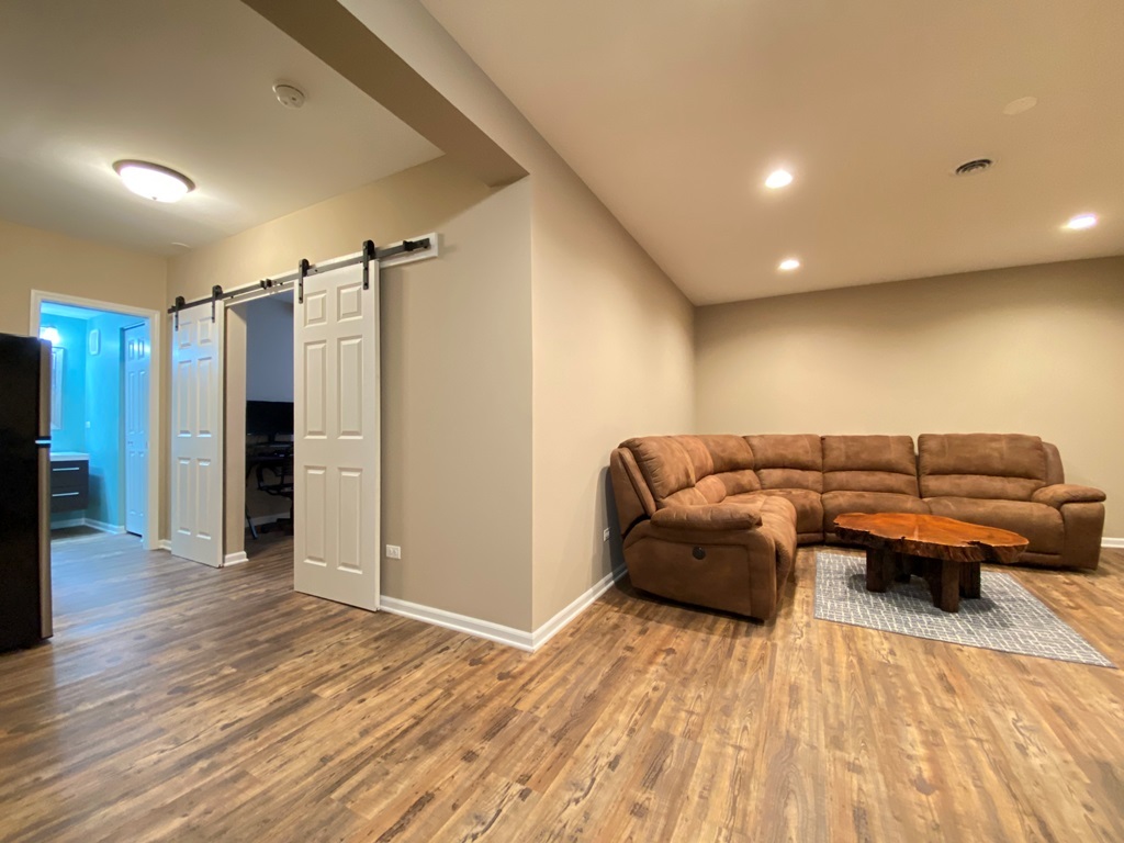 2428 Ridgewood Court Aurora, IL 60502 - Photo 26 of 39 a living room with furniture and a wooden floor