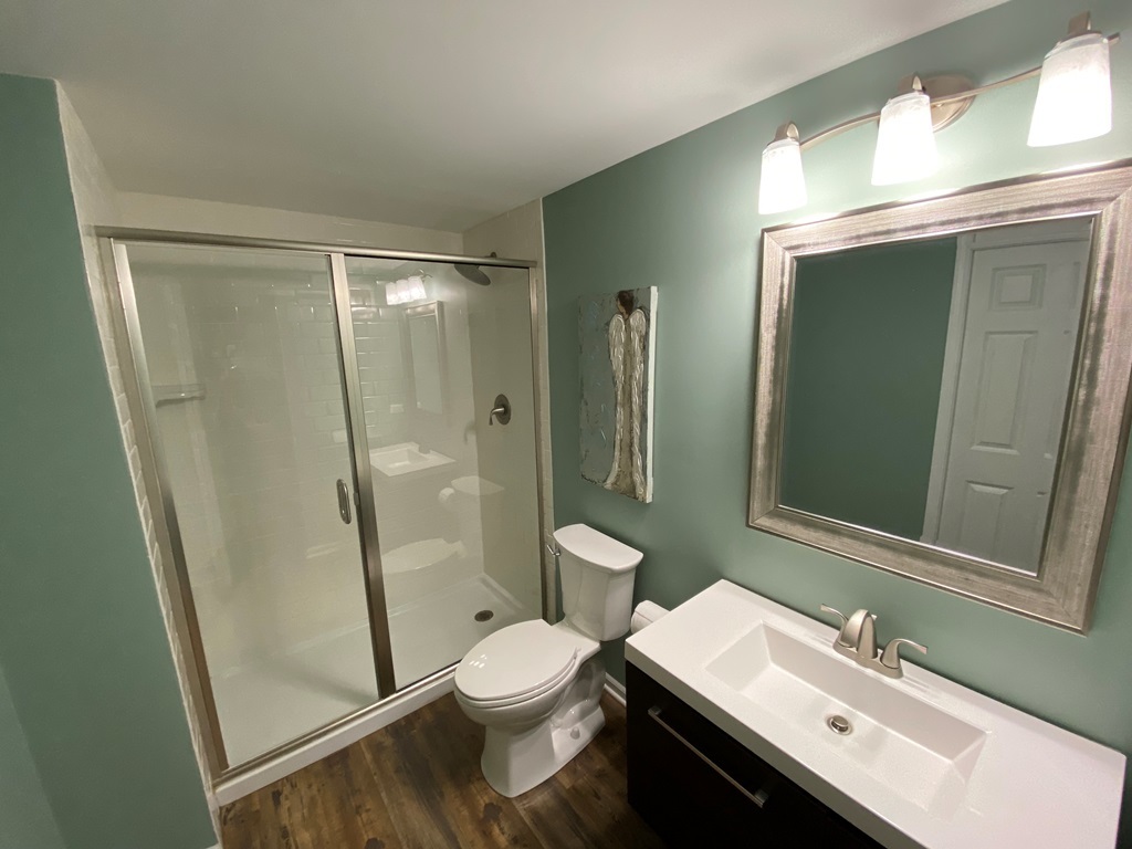 2428 Ridgewood Court Aurora, IL 60502 - Photo 28 of 39 a bathroom with a sink a toilet a mirror and shower