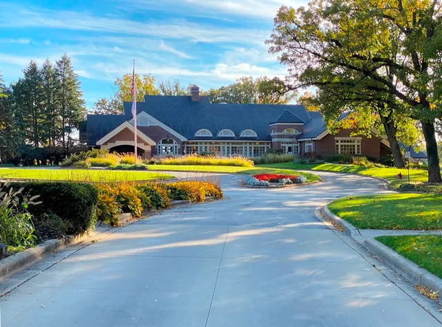 a view of a swimming pool with a lawn chairs under an umbrella