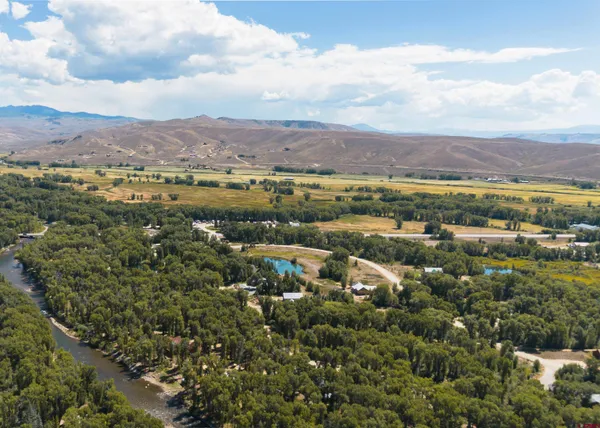 a view of a city with mountains houses and lake view