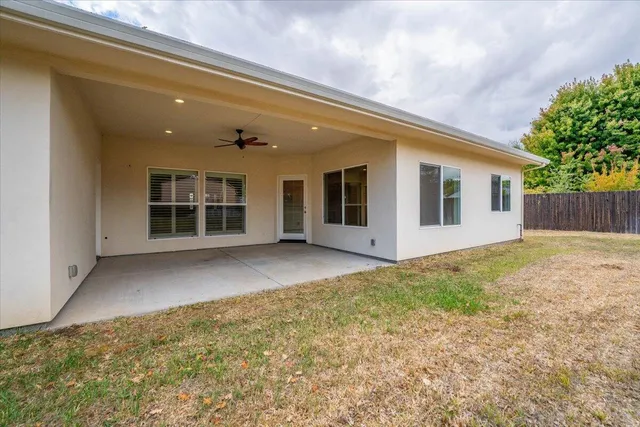 a view of a house with a backyard