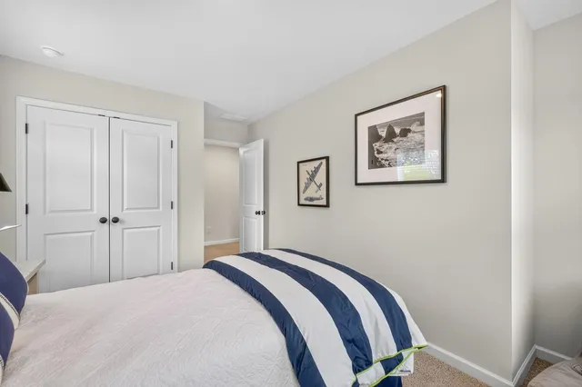 a bedroom with a bed and a ceiling fan