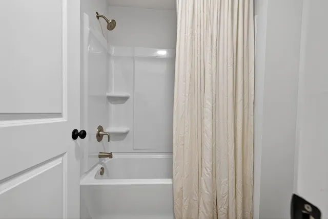 a en suite bathroom with a granite countertop sink and a mirror