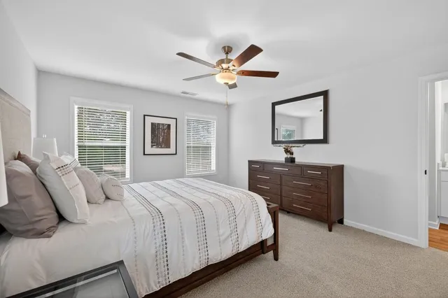 a bed sitting in a bedroom next to a window