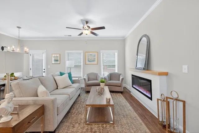 a living room with furniture and a view of kitchen