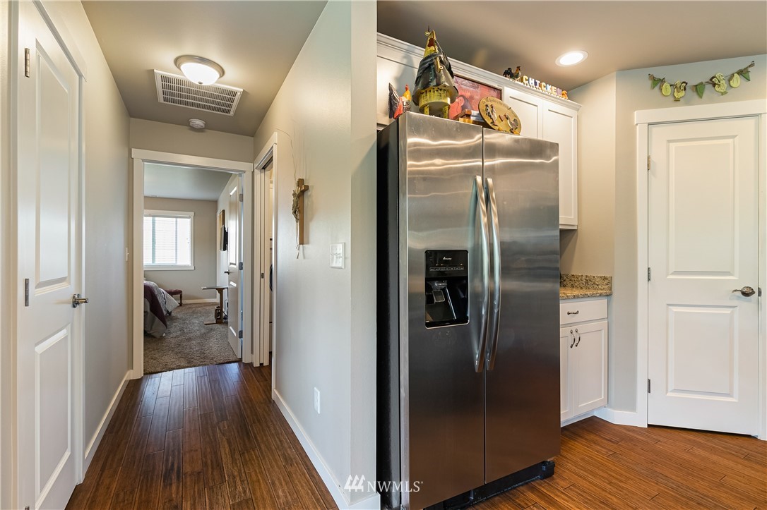 960 Hemlock Loop Lynden, WA 98264 - Photo 14 of 34 a view of a refrigerator in kitchen and wooden floor