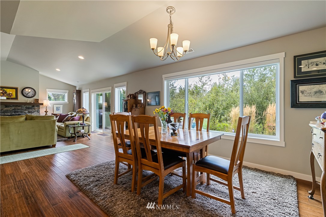 960 Hemlock Loop Lynden, WA 98264 - Photo 8 of 34 a dining room with furniture a chandelier and wooden floor