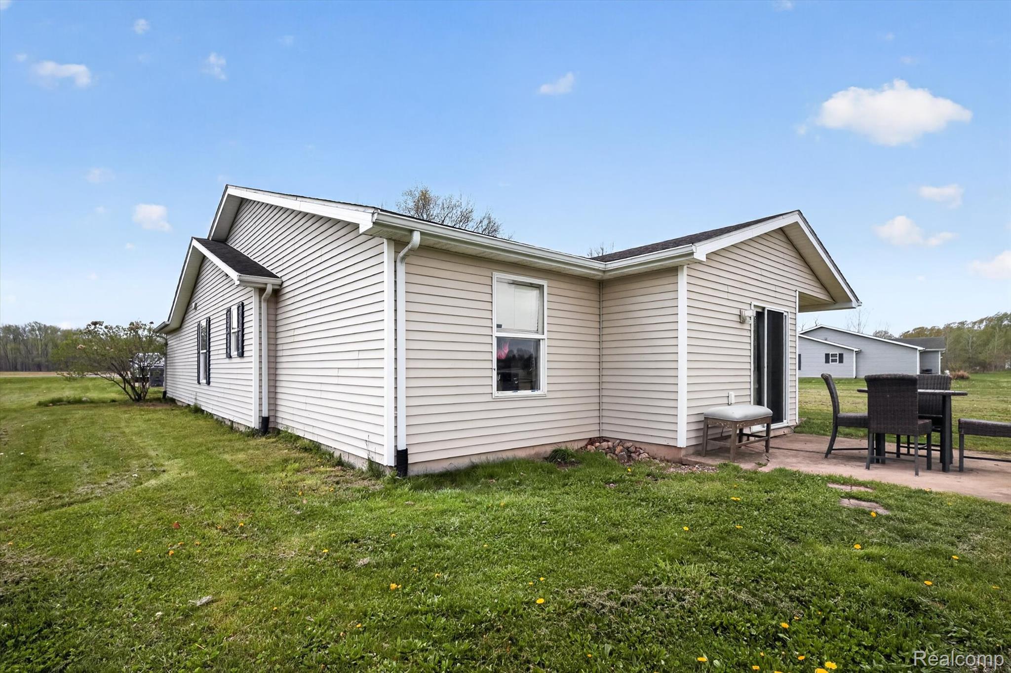 45196 76th Avenue Decatur, MI 49045 - Photo 19 of 23 View of side of home featuring a lawn and a patio area