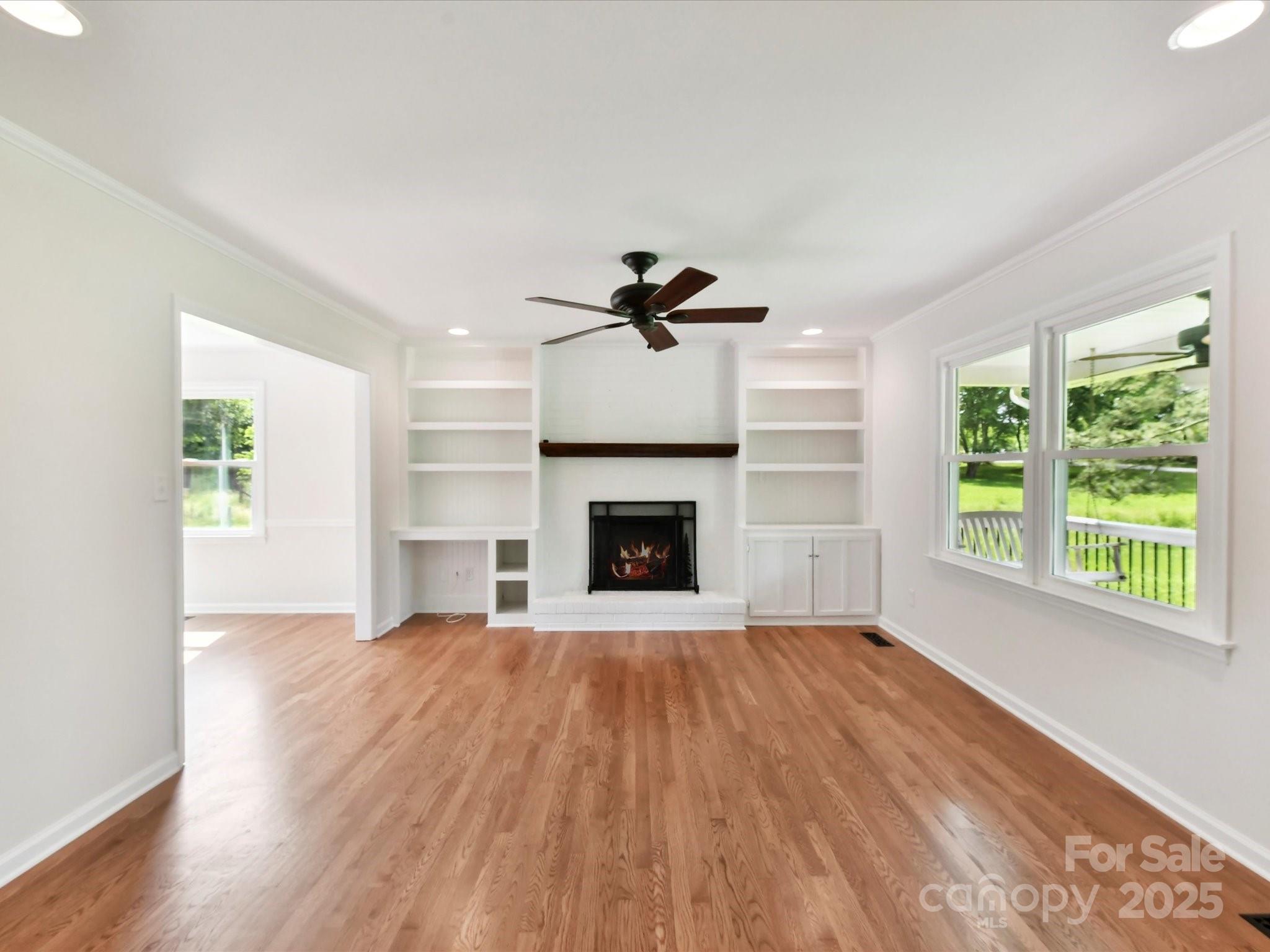 915 Gate Road Monroe, NC 28112 - Photo 11 of 46 a view of an empty room with a fireplace and a window