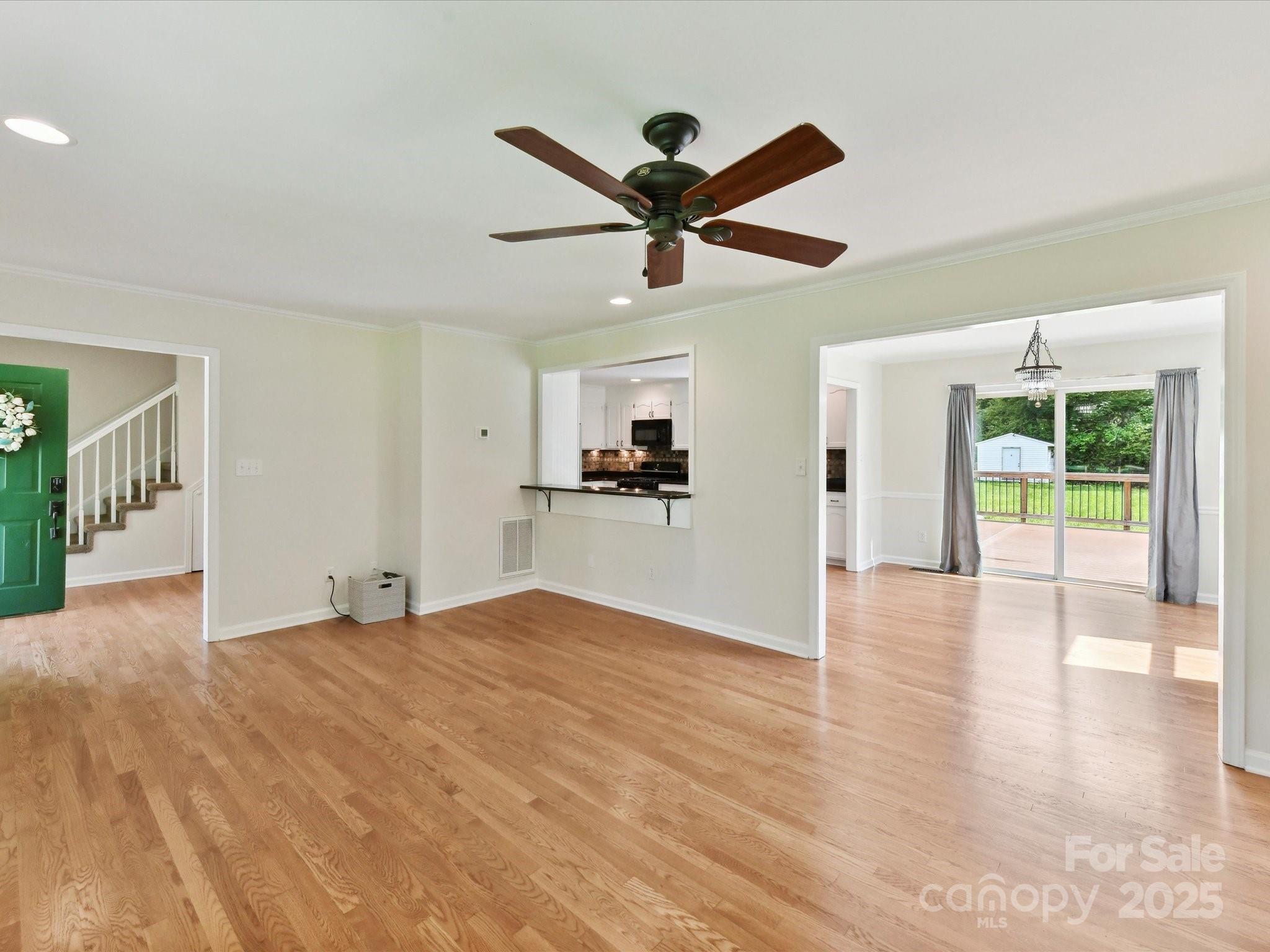 915 Gate Road Monroe, NC 28112 - Photo 12 of 46 a view of a livingroom with a ceiling fan and wooden floor