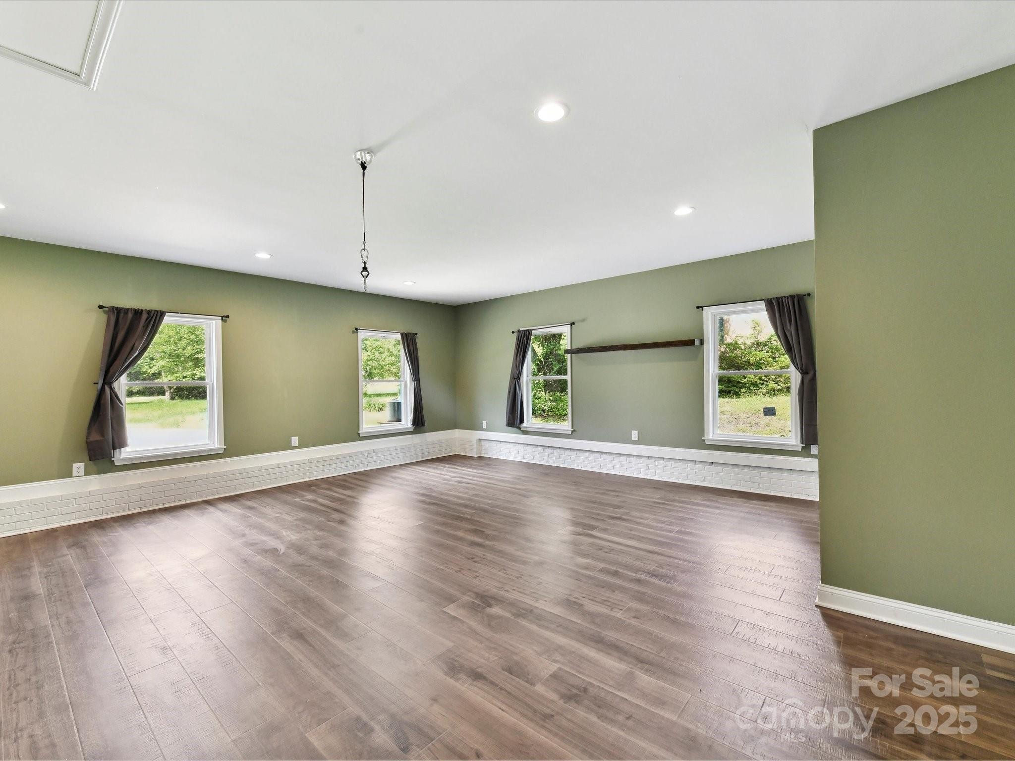 915 Gate Road Monroe, NC 28112 - Photo 22 of 46 an empty room with wooden floor and windows
