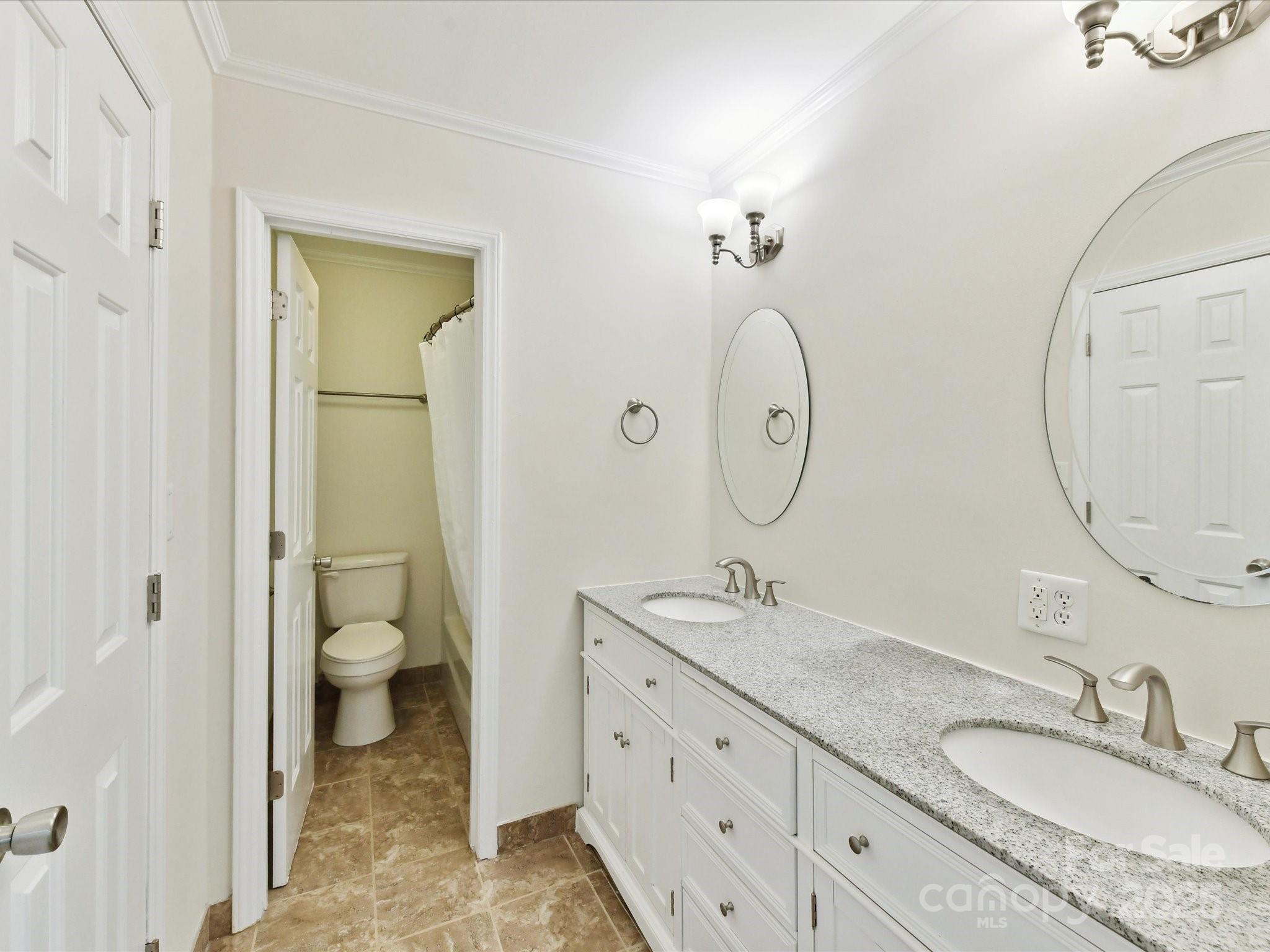 915 Gate Road Monroe, NC 28112 - Photo 26 of 46 a bathroom with double vanity sink and a mirror