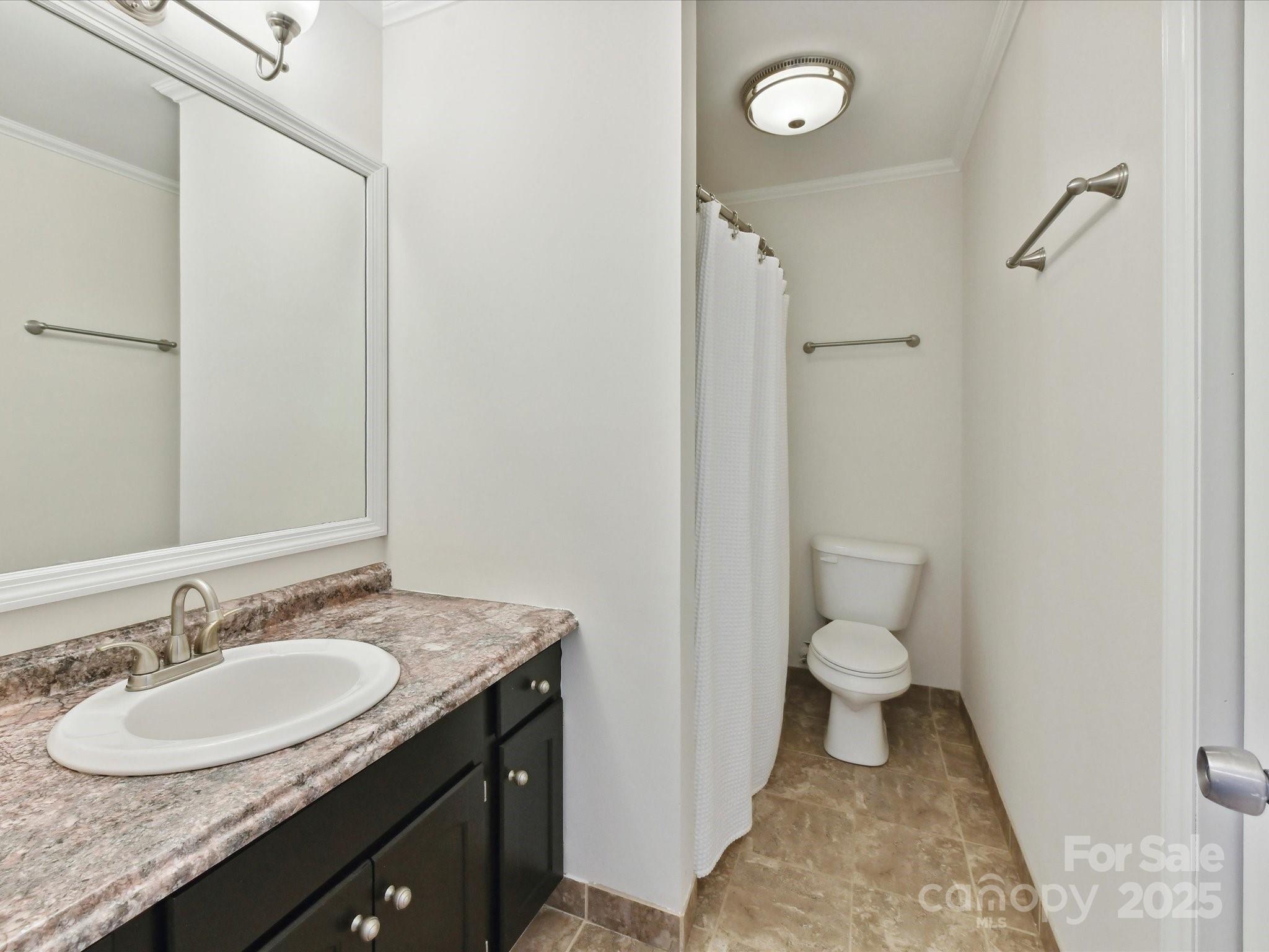 915 Gate Road Monroe, NC 28112 - Photo 28 of 46 a bathroom with a granite countertop sink toilet and a mirror