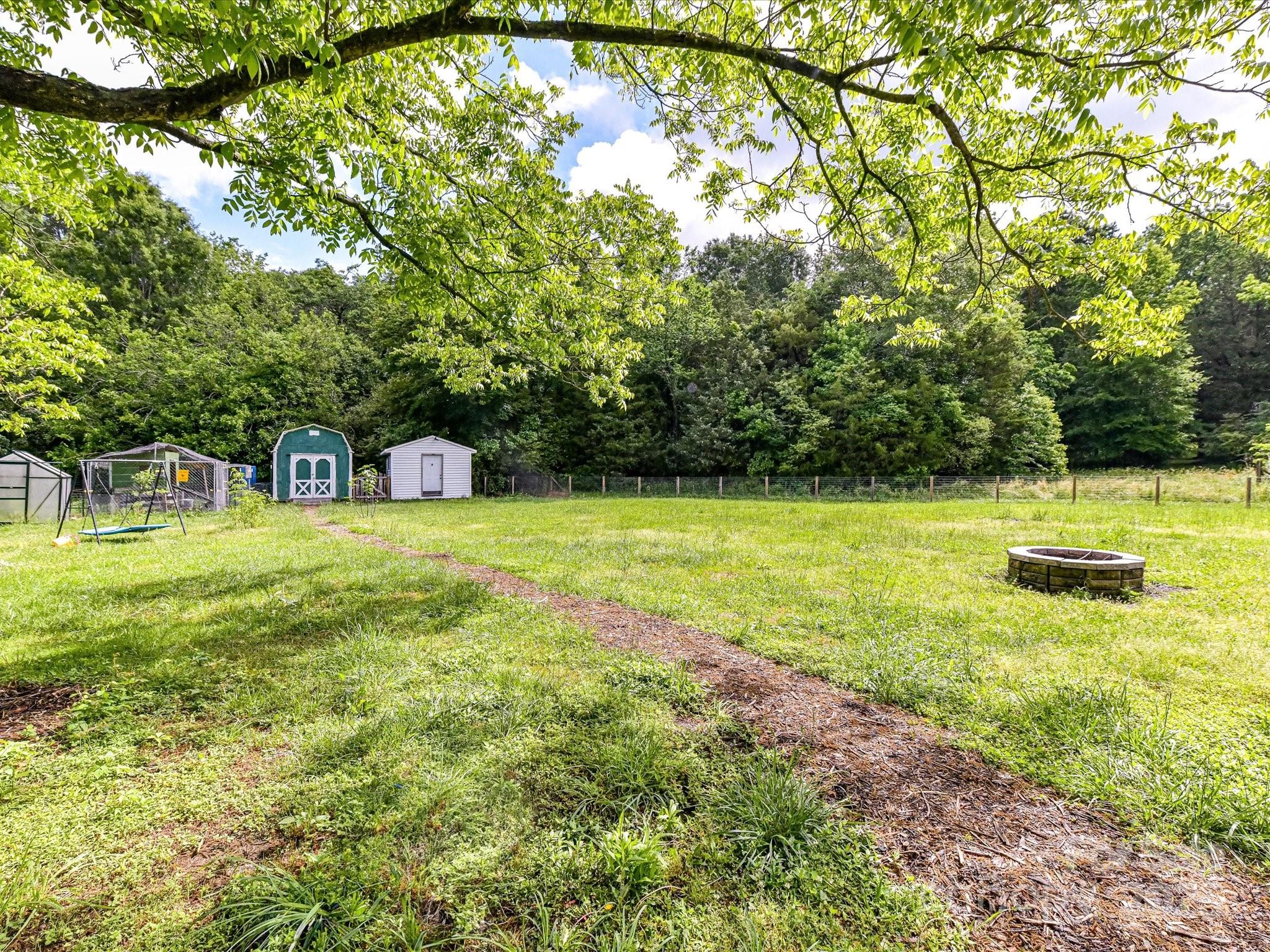 915 Gate Road Monroe, NC 28112 - Photo 35 of 46 a view of a swimming pool with a bench