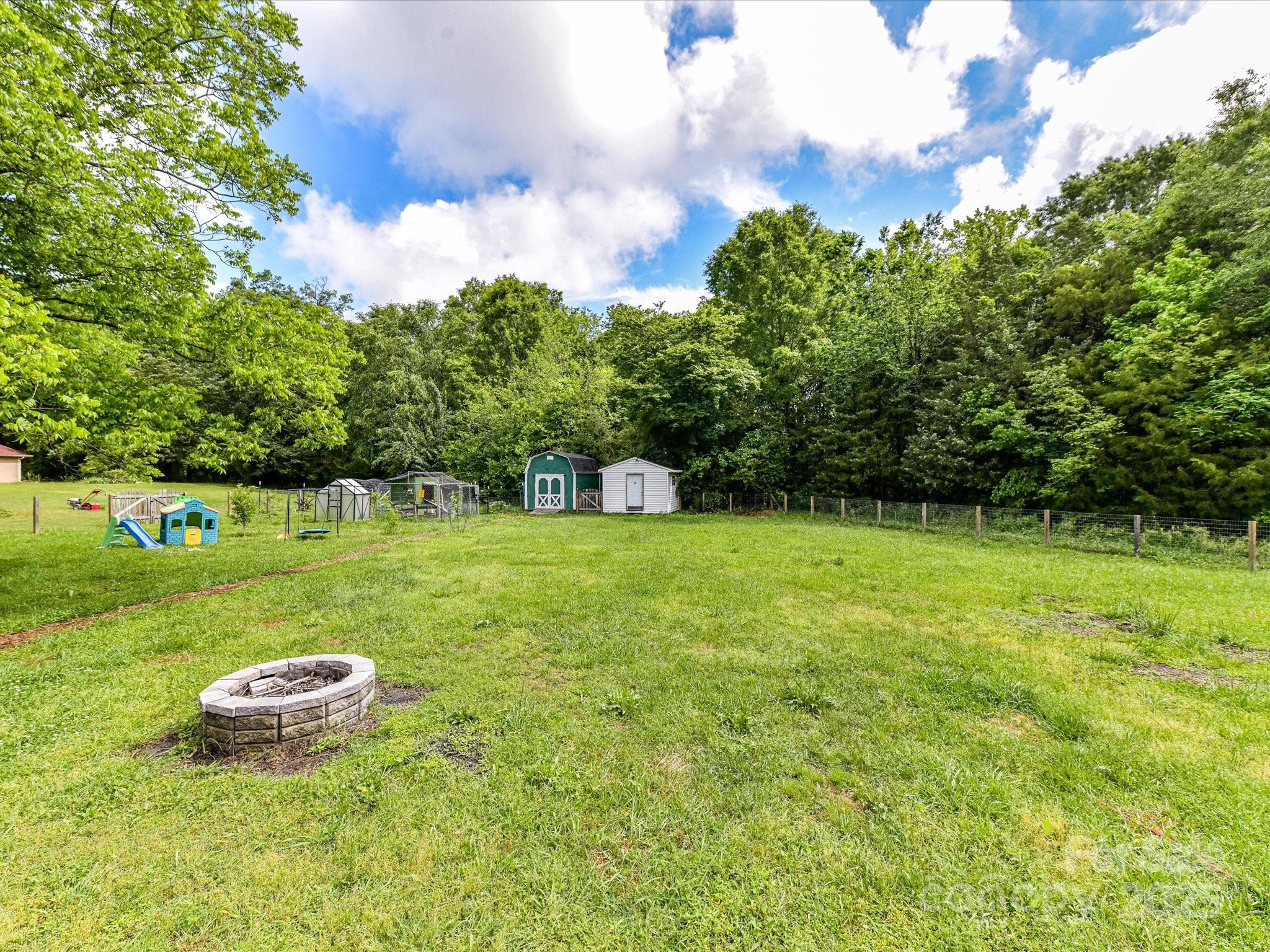 915 Gate Road Monroe, NC 28112 - Photo 39 of 46 a view of a garden with a fountain