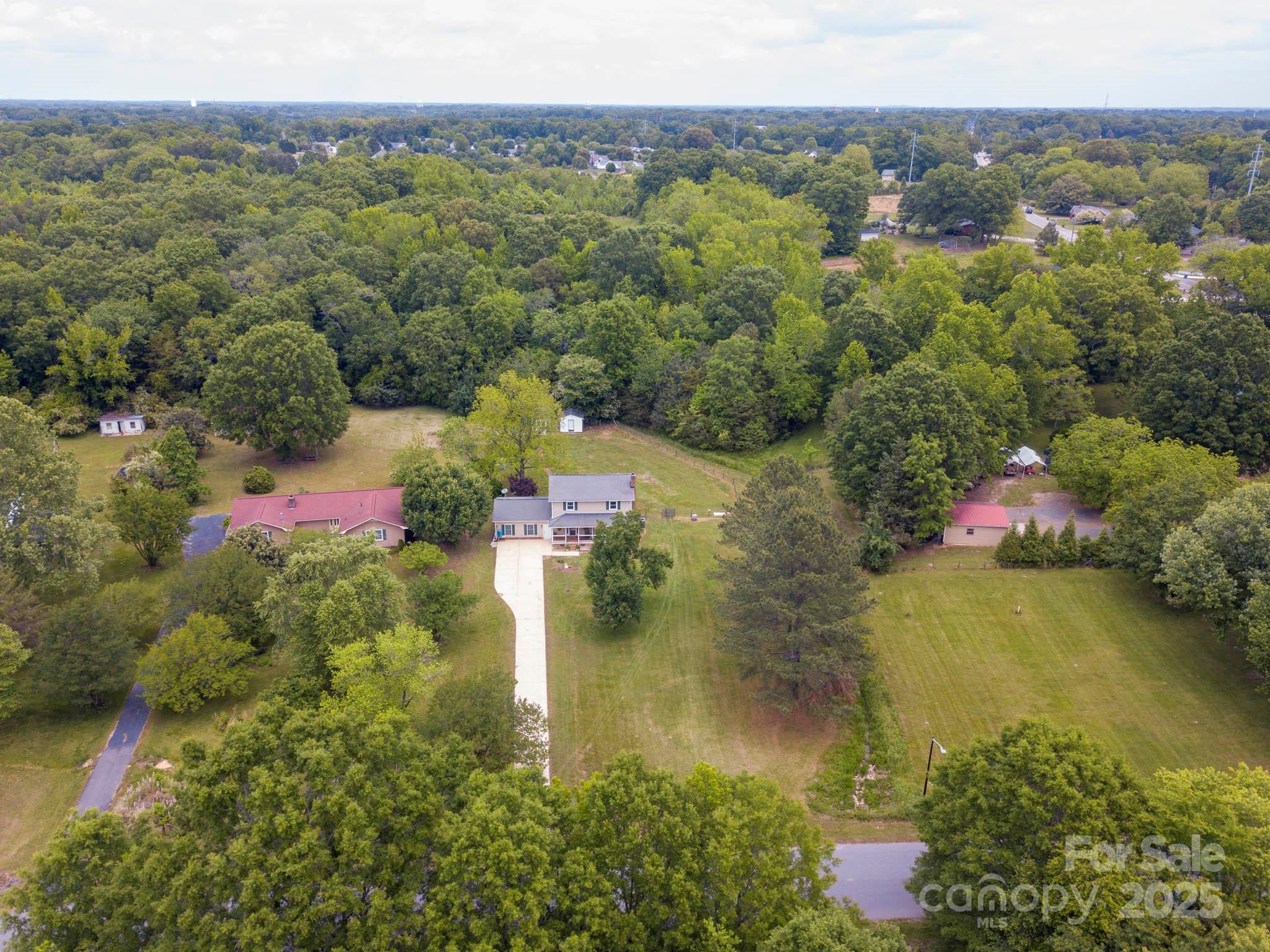 915 Gate Road Monroe, NC 28112 - Photo 43 of 46 an aerial view of residential houses with outdoor space and trees all around