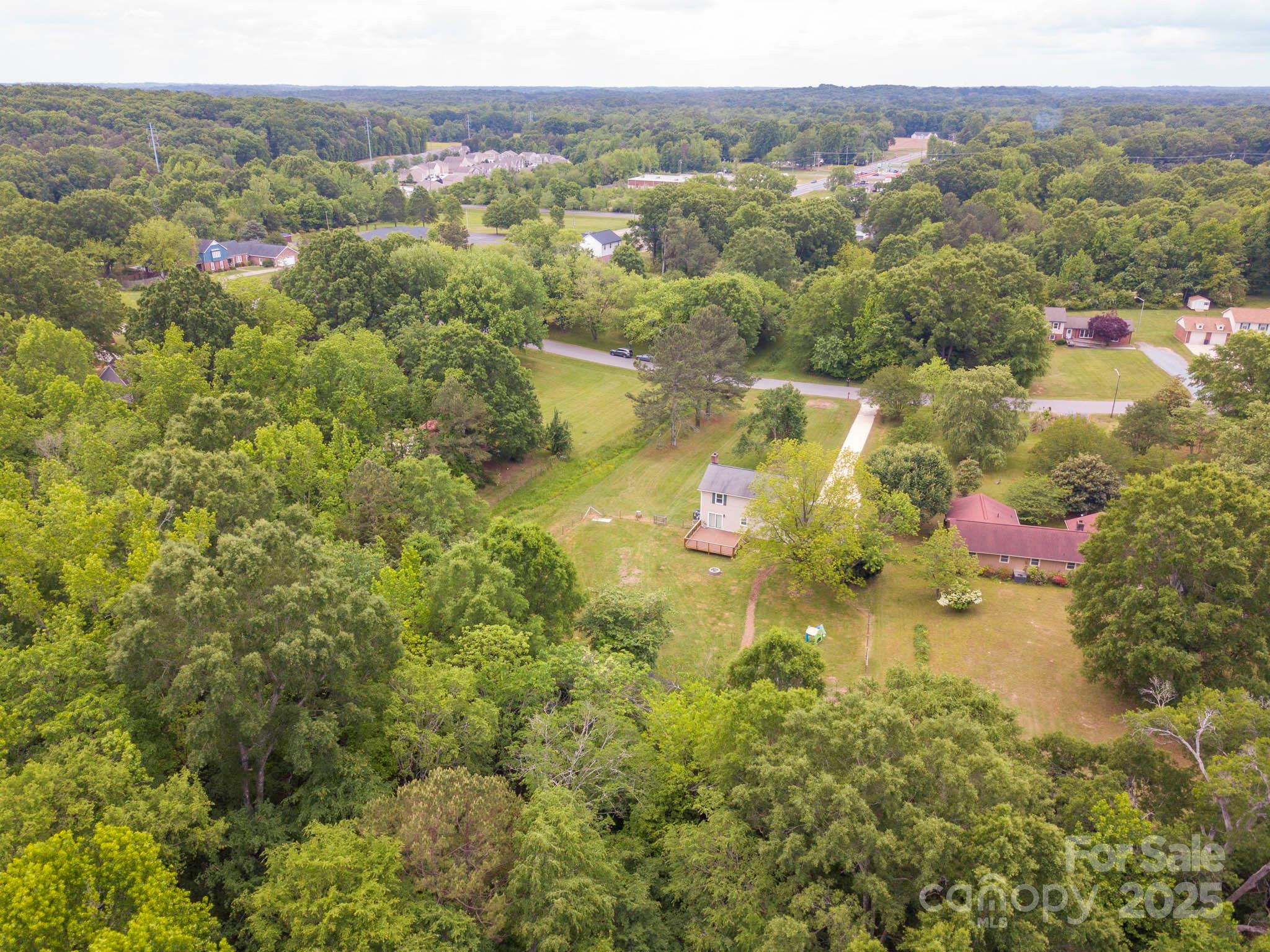 915 Gate Road Monroe, NC 28112 - Photo 44 of 46 an aerial view of residential houses with outdoor space and trees