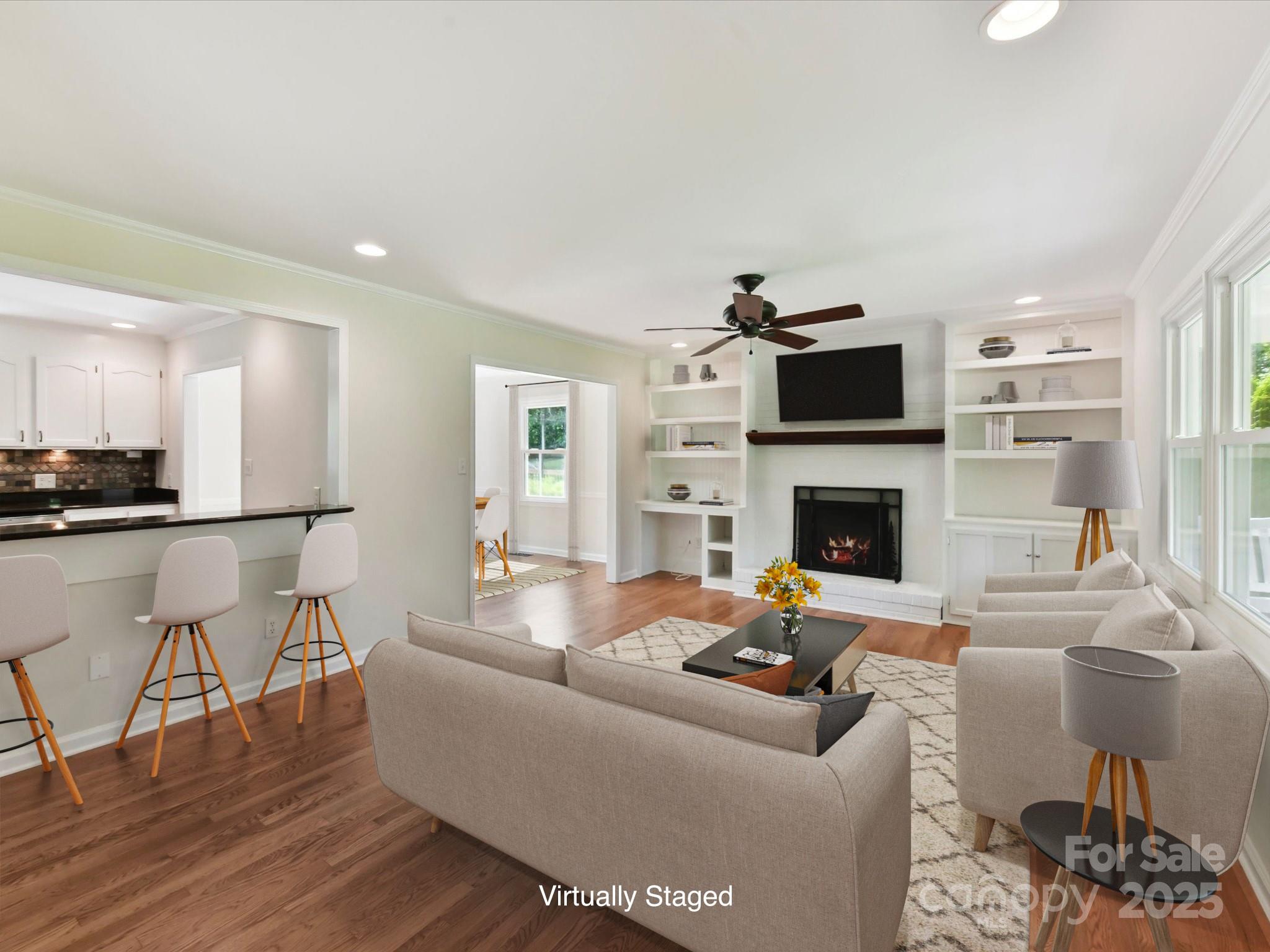 915 Gate Road Monroe, NC 28112 - Photo 9 of 46 a living room with furniture a flat screen tv and a fireplace