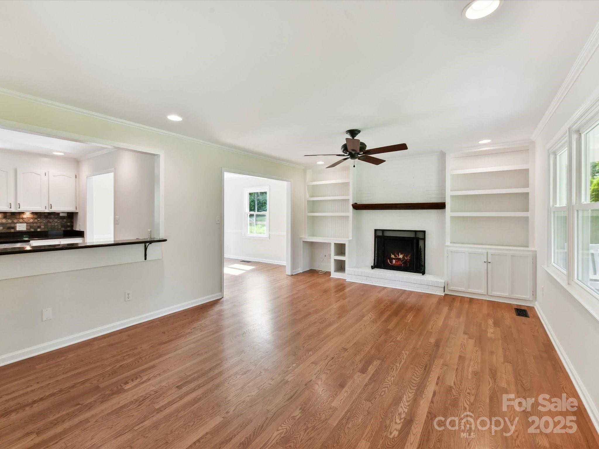 915 Gate Road Monroe, NC 28112 - Photo 10 of 46 a view of empty room with wooden floor and fireplace