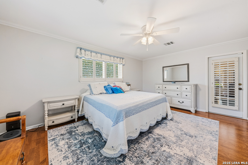 6022 Winding Ridge Drive Windcrest, TX 78239 - Photo 20 of 31 a spacious bedroom with a bed and a chandelier