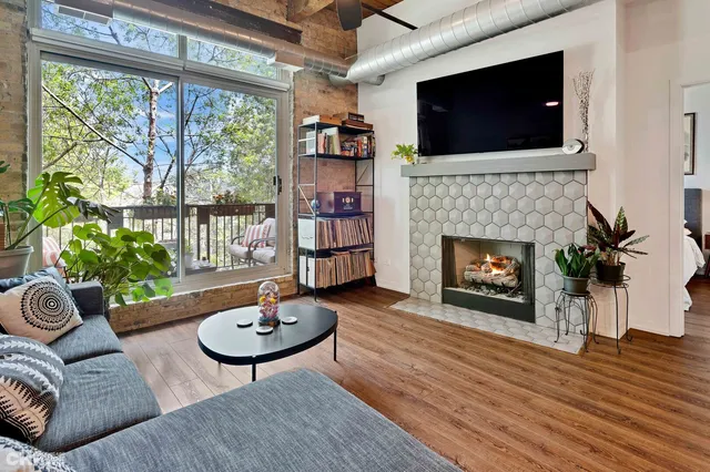 a living room with furniture and a floor to ceiling window