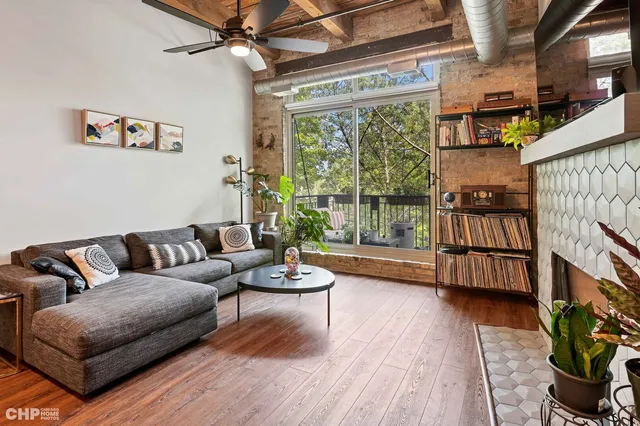 a balcony with wooden floor table and chairs